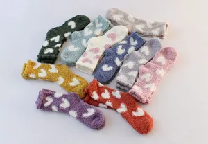 Cozy fuzzy plush socks for women featuring cute heart patterns, thick warm coral fleece winter socks.