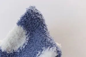 Close-up detail of soft coral fleece winter warm socks featuring cozy fuzzy fabric texture.