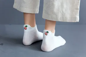 Cute white cotton ankle socks for women, featuring a sweet peach embroidery at the back heel.