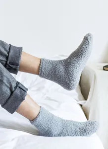 Soft fluffy grey sleep socks detail shot, cozy winter home fuzzy floor socks cozy texture.