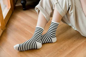 Women's black and white striped crew socks, comfortable cotton casual daily wear hosiery.