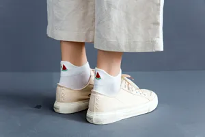 Detail view of pure white women short socks featuring cute 3D embroidered watermelon designs.