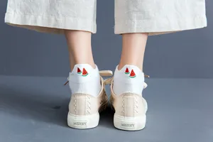 Close-up detail of white women short ankle socks featuring cute watermelon embroidery design.