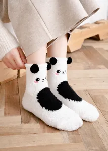 Close-up view of fluffy panda fuzzy socks, ultra soft coral fleece for warm winter comfort.