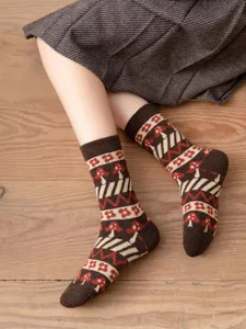 Detailed view of women milk coffee wool socks with retro mushroom pattern, cozy and warm.