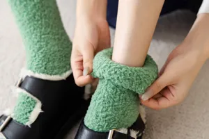 Cozy green coral fleece socks detail shot, soft fluffy texture, warm winter ankle socks display.
