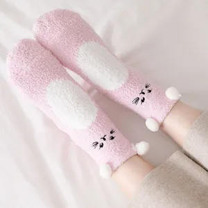 Cute fuzzy coral fleece warm winter socks for women with cute cat ears and thick plush floor design.