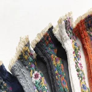 Close-up detail of Japanese vintage floral lace socks, showcasing delicate embroidery and ruffles.