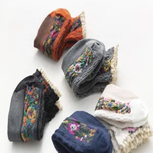 Detailed view of Japanese vintage floral embroidered women socks with delicate lace trim.