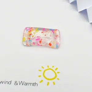 Resin candy charm detail shot with colorful confetti inside, perfect for DIY crafts.