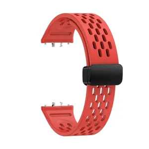 Close-up detail view of the red silicone watch strap with breathable holes and magnetic clasp.