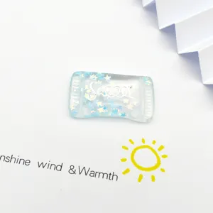 Detailed shot of resin crystal candy charm with blue stars for DIY jewelry and phone case.