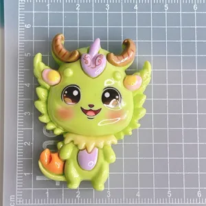 Detailed view of a cute green dragon resin cabochon charm, perfect for DIY phone cases and crafts.