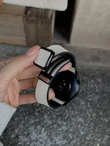 Detail shot of white litchi pattern leather watch strap with black magnetic folding clasp.