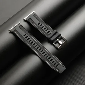Detail view of black silicone woven watch strap with metal buckle and connector, textured design.