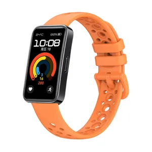 Silicone replacement strap for smart band, breathable porous orange wristband detail view.