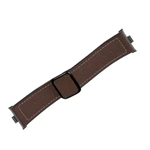 Brown litchi grain leather watch strap detail, magnetic buckle and black connector close-up.