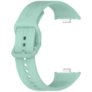 Green silicone replacement watch strap close-up detail, showing buckle and connector.