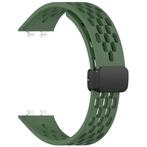 Close-up of green silicone watch band featuring breathable perforated design and magnetic clasp.