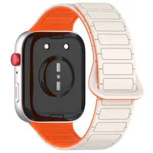 Magnetic silicone smartwatch replacement strap featuring dual tone orange and white design.