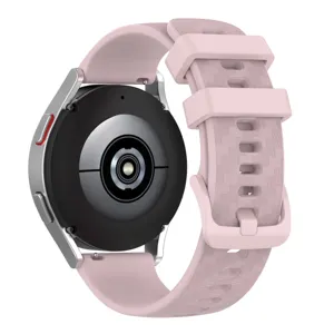 Pink silicone watch strap with carbon fiber texture and matching buckle for smartwatches detail view.