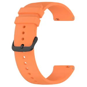 Orange silicone watch strap detail, featuring black buckle and quick release pins.