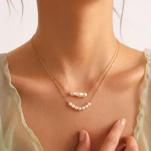 Close-up detail of double layer baroque pearl titanium steel clavicle necklace jewelry.