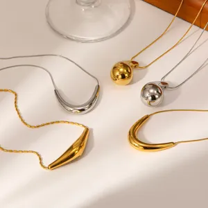 Detail showcase of minimalist 18K gold plated titanium steel teardrop and arc pendant necklaces.