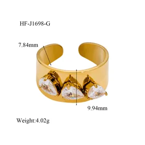 Gold open ring featuring three pear-cut zirconia stones, chic fashion jewelry detail view.