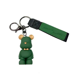 Cute green bear keychain with silicone doll pendant and stylish fabric strap for daily use.