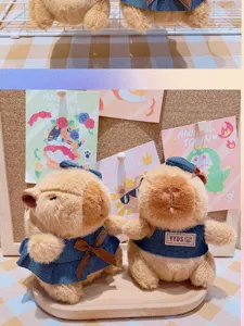 Cute capybara plush keychain toy featuring a stylish denim outfit and soft bag pendant.