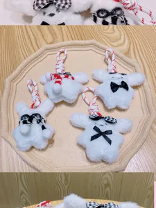 Plush puppy keychain detail showing cute plush dog pendants with bow ties, scarves and ropes.