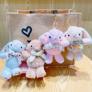 Simpatici portachiavi di peluche con coniglio dalle orecchie lunghe e fiocchi floreali.