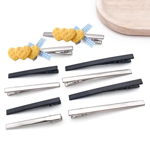 Metal alligator hair clips set with cute biscuit heart bow charms and solid black silver finish.