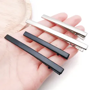 Close-up detail shot of metal duckbill hair clips in silver and black colors for DIY crafts.