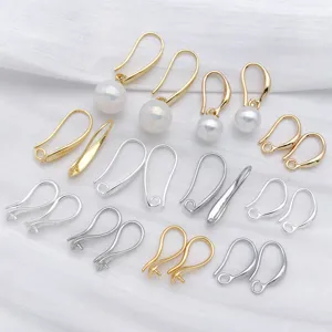 Gold and silver DIY earring hooks and pearl holders jewelry making accessories details view.