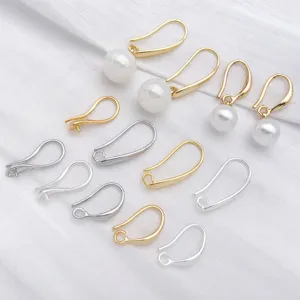 Close-up of DIY jewelry making gold and silver ear hooks with bead tray for handmade earrings.