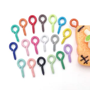 Colorful mini screw eyes for DIY jewelry making, small metal eyelet pins detail shot.