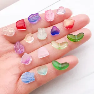 Close-up of colorful gradient glass leaf tulip and heart beads for DIY bracelet jewelry