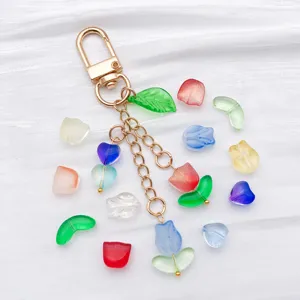 Detailed view of colorful gradient glass tulip, leaf and heart beads with metal keychain charm.