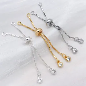 Detailed view of adjustable sliding extension chains with silicone beads and cubic zirconia charms.