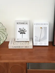 Minimalist botanical art simulation book detail, elegant home decor storage book display setup.