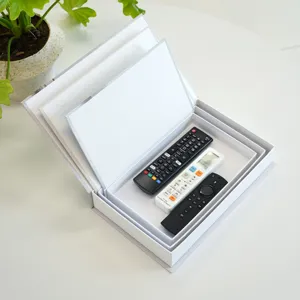 Detail view of Nordic minimalist storage book box with multi-layer tray holding remotes.