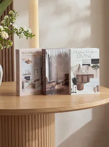 Nordic style decorative simulation books set on wooden table, elegant home staging detail.