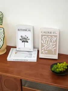 Decorative fake books set with botanical art prints for modern home decor and coffee table.
