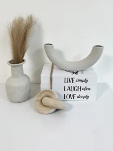Rustic decorative storage book detail with ceramic vase and wooden knot for home decor.