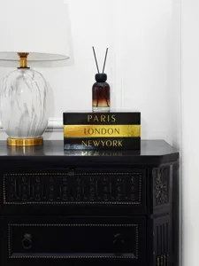 Luxury decorative storage book box set with gold foil city prints for modern home decor display.