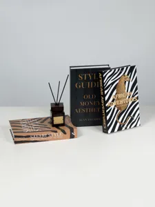 Detailed shot of luxury decorative coffee table books and reed diffuser set for home decor.