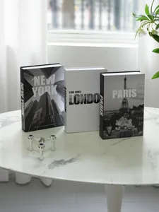Detail view of decorative simulation books with New York, London, and Paris city themes.