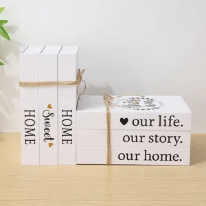 Close-up of white decorative fake books with English text, ideal for modern home and cafe decor.